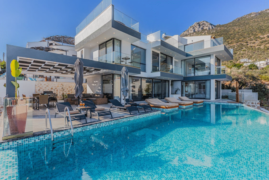 luxurious home with a big connected pool in the backyard with patio furniture