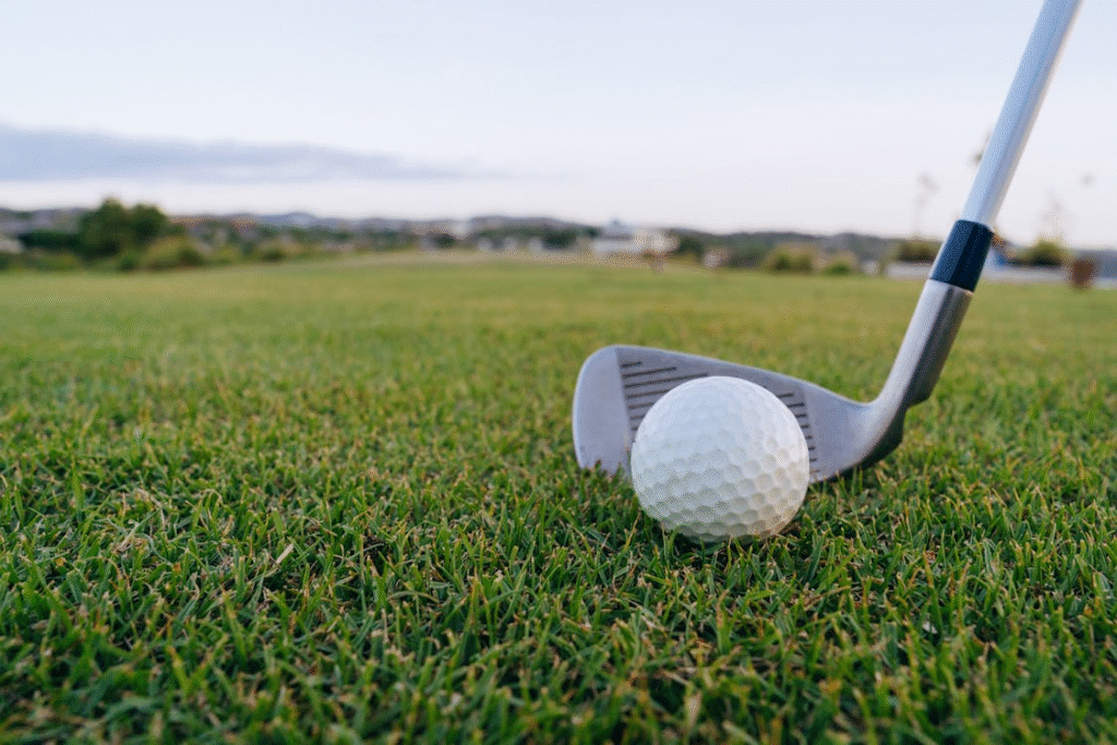close-up of a golf ball on green grass at the golf course about to be hit