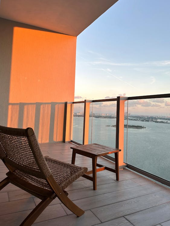 high-rise condo with a patio chair and glass fence with a waterfront view